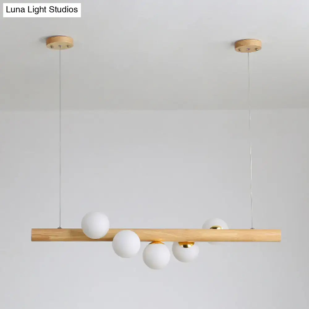 Minimalist wood and glass linear island pendant for kitchen lighting