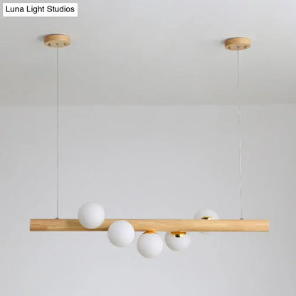 Minimalist wood and glass linear island pendant for kitchen lighting