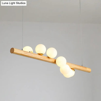 Minimalist wood and glass linear island pendant for kitchen lighting