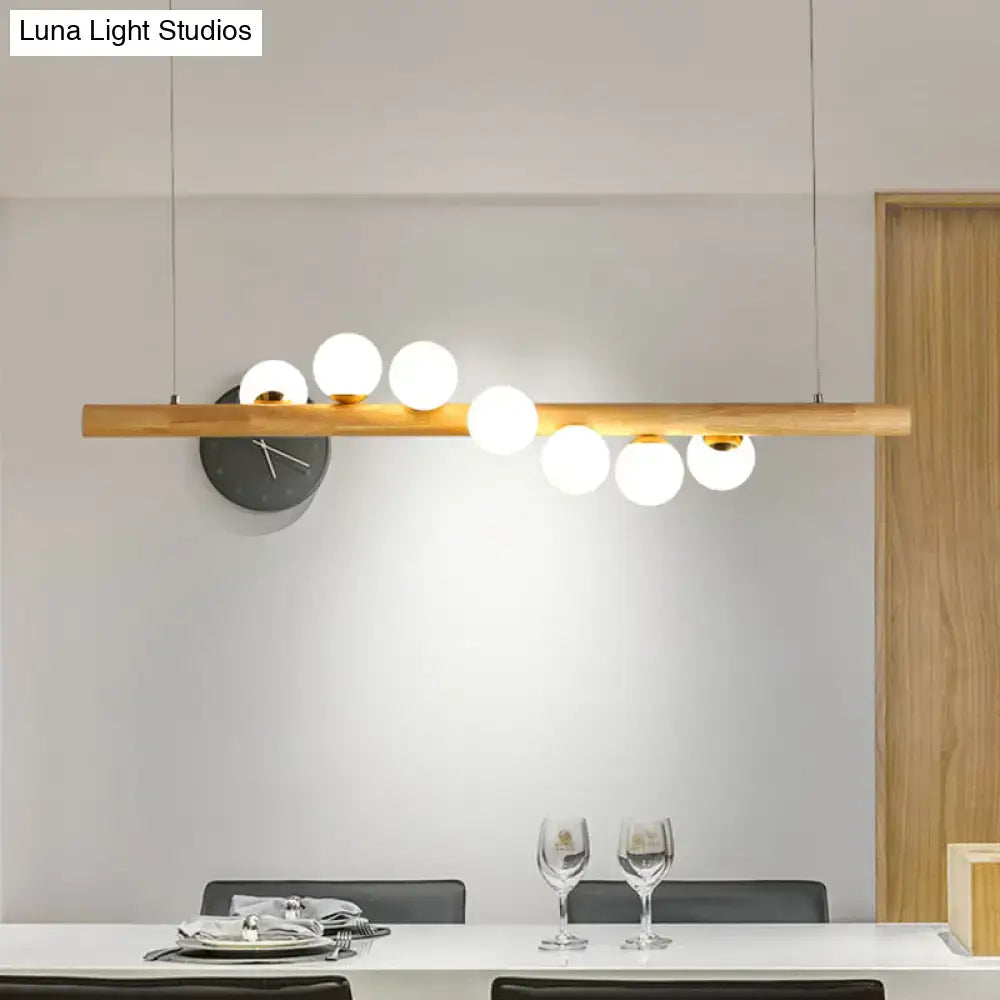 Minimalist wood and glass linear island pendant for kitchen lighting