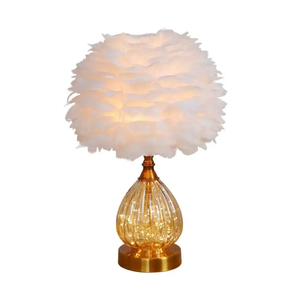 Modern amber glass droplet night light with white feather shade bedroom