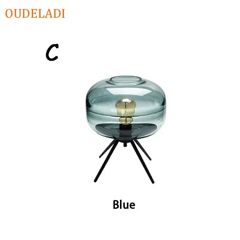 Modern amber glass table lamp with black tripod base for bedroom decor
