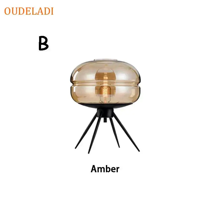 Modern amber glass table lamp with black tripod base for bedroom decor