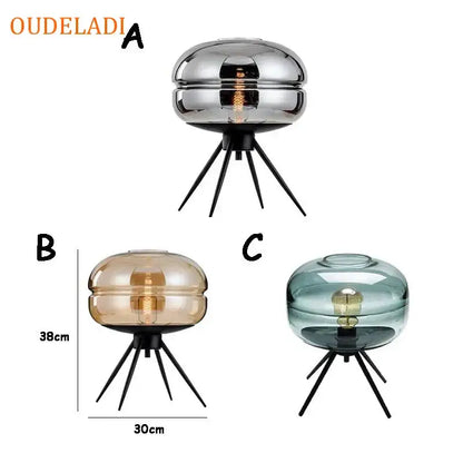 Modern amber glass table lamp with black tripod base for bedroom decor