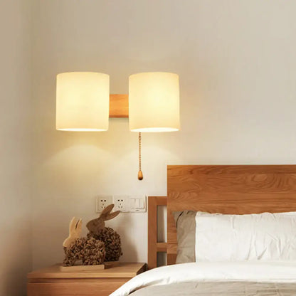 Modern beige fabric and wood wall light bedroom sconce with pull chain