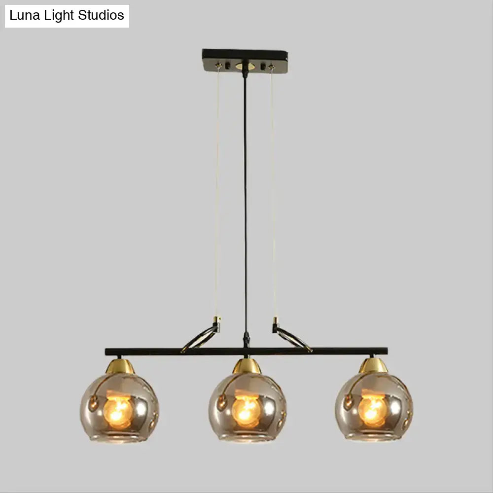 Modern black and brass 3-bulb smoke gray glass pendant dining hall island