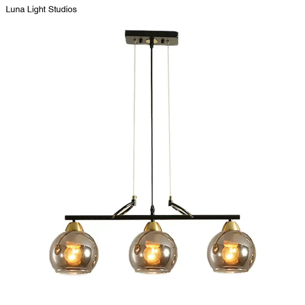 Modern black and brass 3-bulb smoke gray glass pendant dining hall island