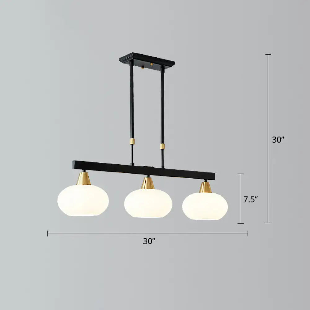 Modern black and brass linear hanging lamp with oval opal glass dining room