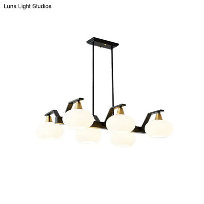 Modern black and brass linear hanging lamp with oval opal glass dining room