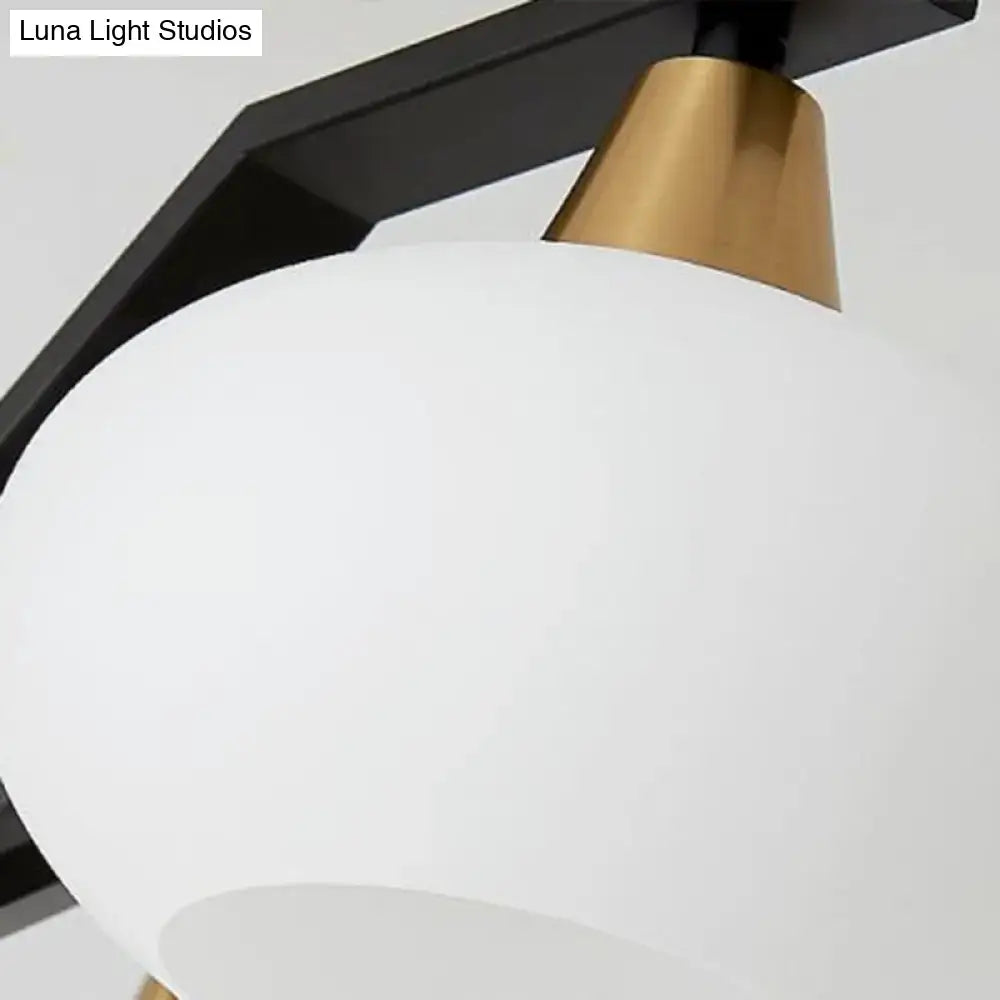 Modern black and brass linear hanging lamp with oval opal glass dining room