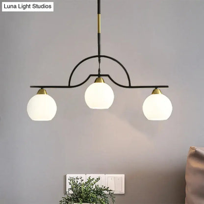 Modern black and brass pendant light with clear glass – kitchen island