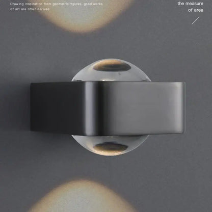 Modern black and copper bedroom wall lamp with glass dome
