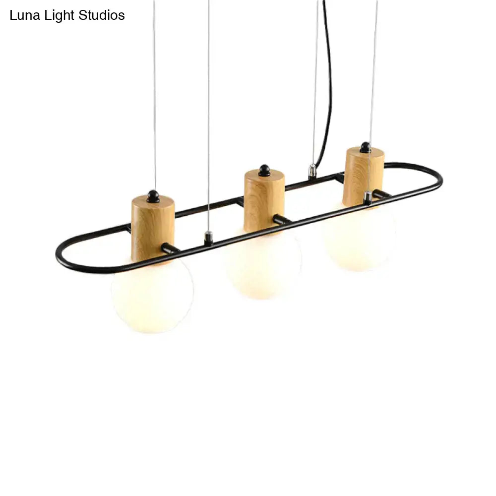 Modern black and wood frosted glass orb pendant light kitchen island