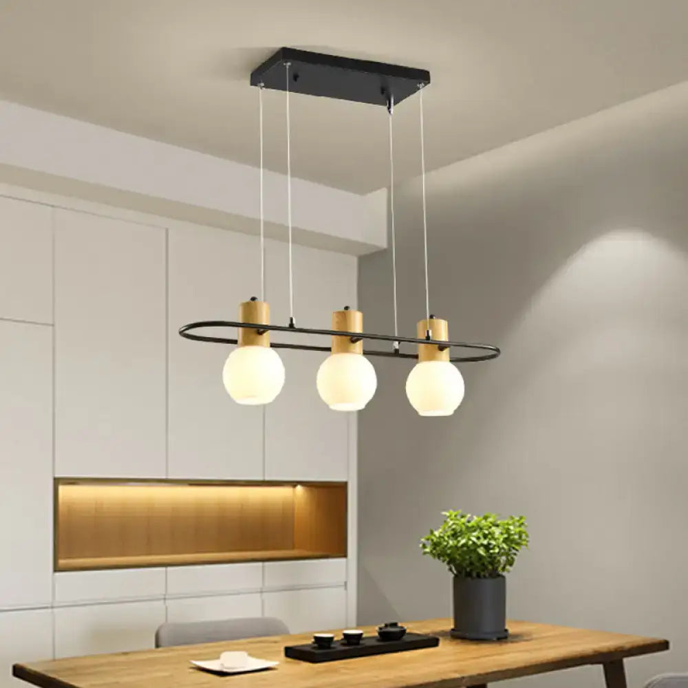 Modern black and wood frosted glass orb pendant light kitchen island