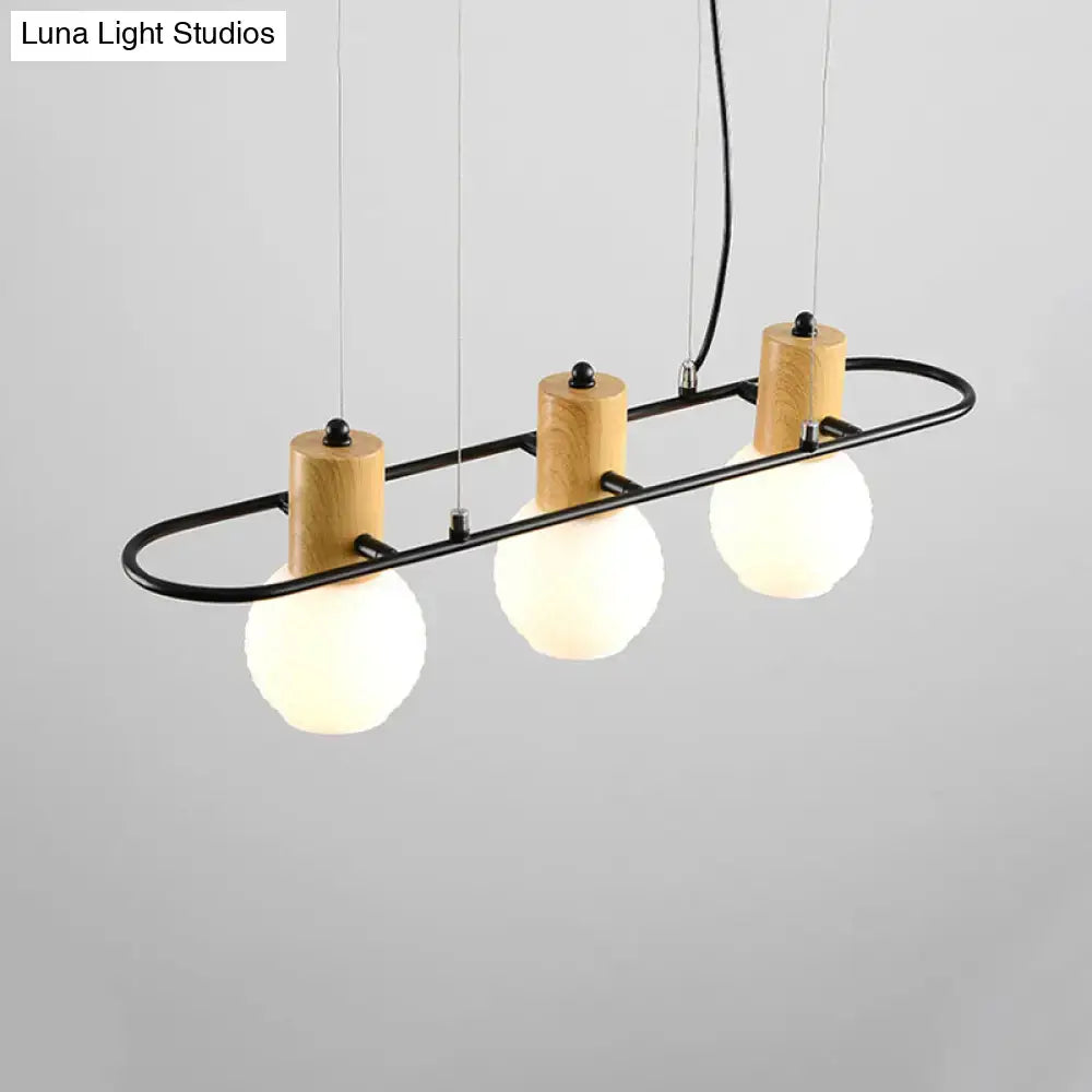 Modern black and wood frosted glass orb pendant light kitchen island