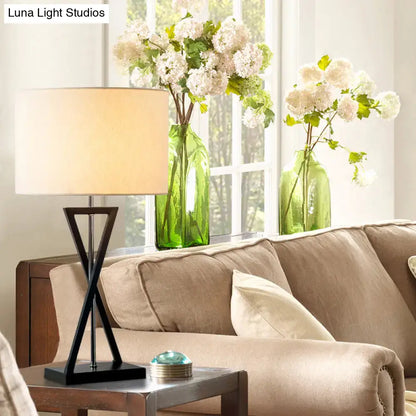 Modern black geometric nightstand lamp with cream drum shade bedroom