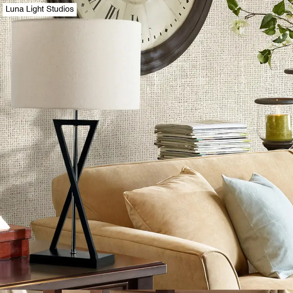 Modern black geometric nightstand lamp with cream drum shade bedroom