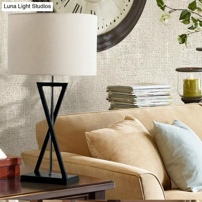 Modern black geometric nightstand lamp with cream drum shade bedroom
