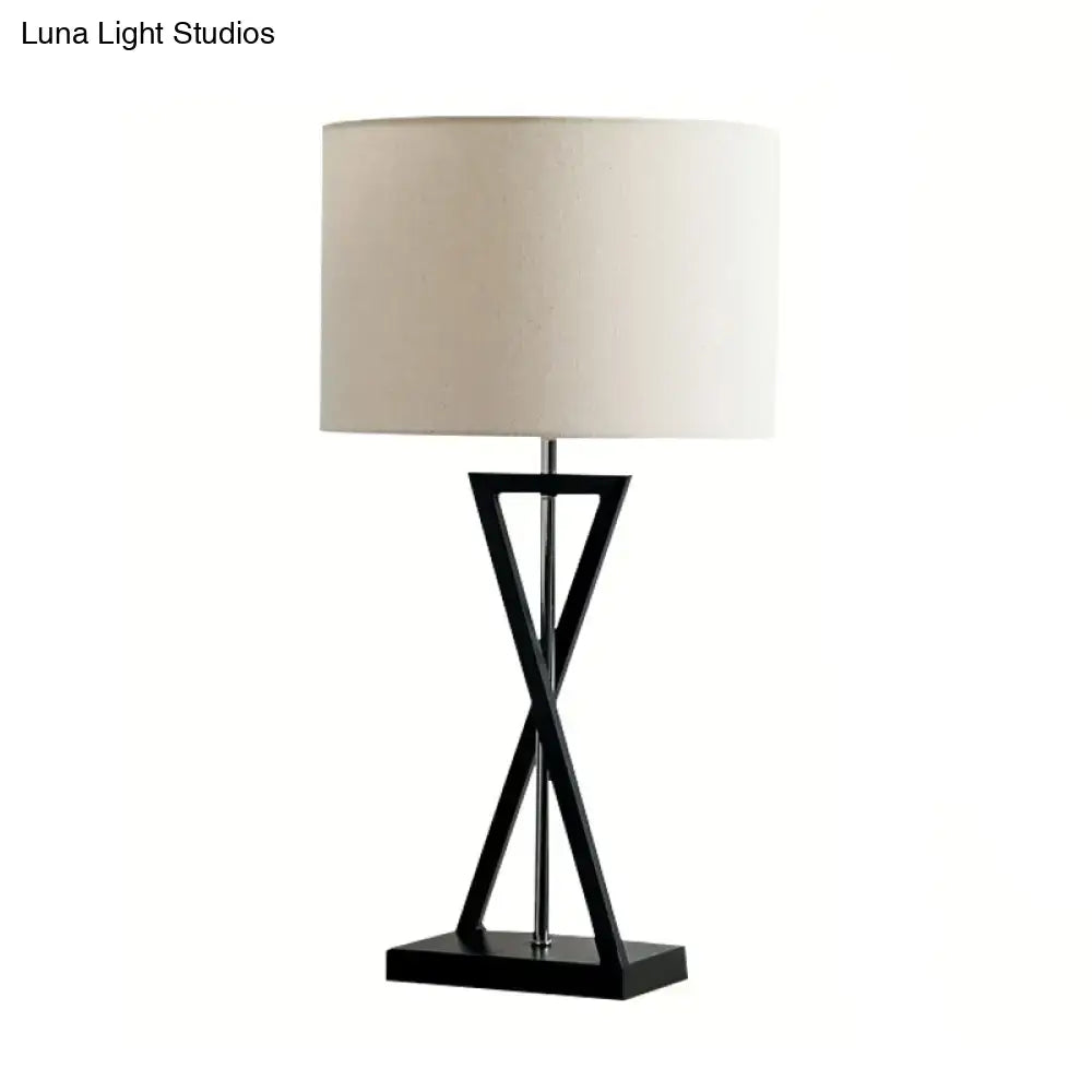 Modern black geometric nightstand lamp with cream drum shade bedroom