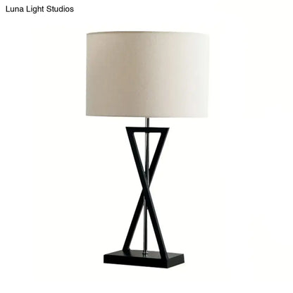 Modern black geometric nightstand lamp with cream drum shade bedroom