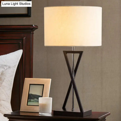 Modern black geometric nightstand lamp with cream drum shade bedroom
