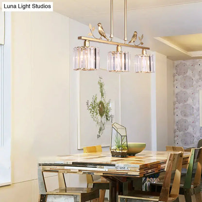 Modern black & gold bird pendant light with clear crystal drum shade