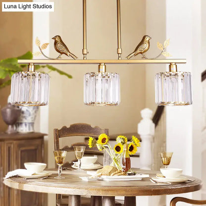 Modern black & gold bird pendant light with clear crystal drum shade