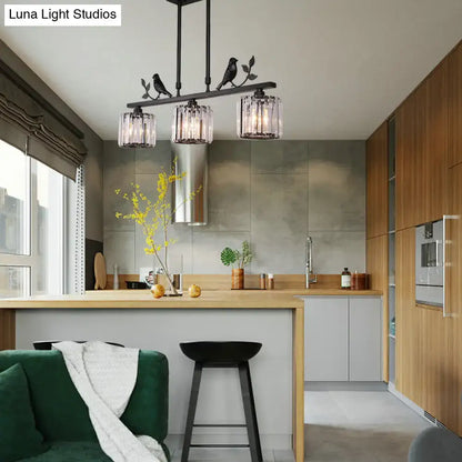 Modern black & gold bird pendant light with clear crystal drum shade