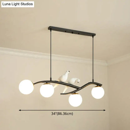 Modern black island pendant light with birds for dining room