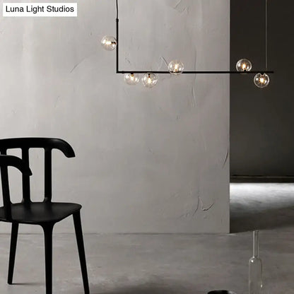 Modern black linear island pendant with glass shade dining room