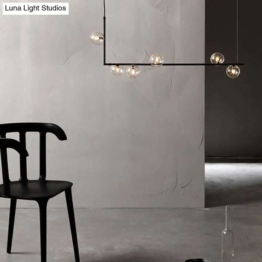 Modern black linear island pendant with glass shade dining room