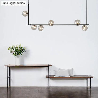Modern black linear island pendant with glass shade dining room