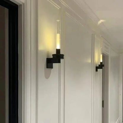 Modern black metal wall light with clear glass shade for bedroom