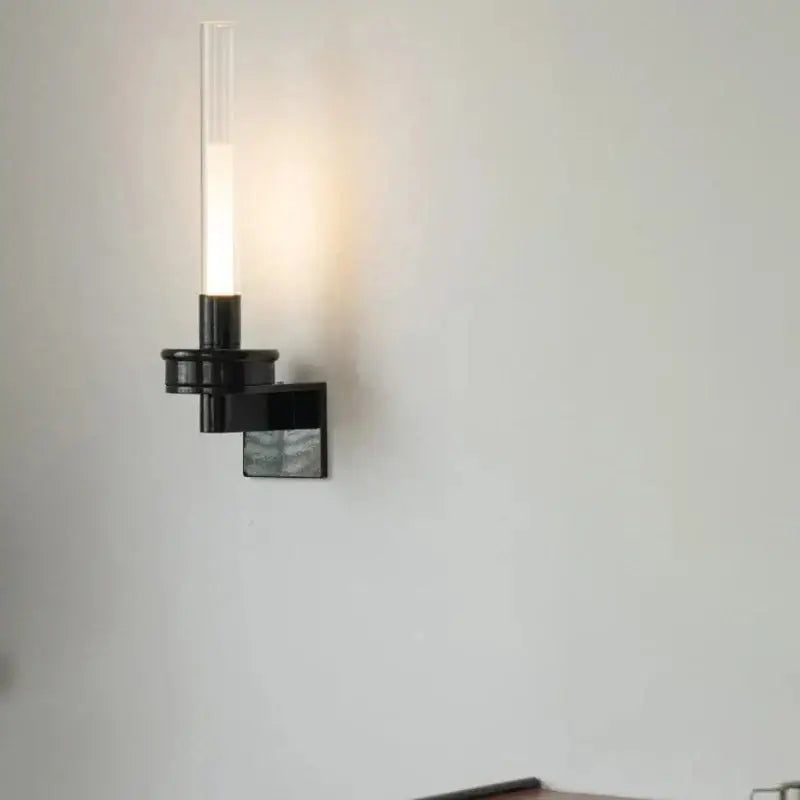 Modern black metal wall light with clear glass shade for bedroom