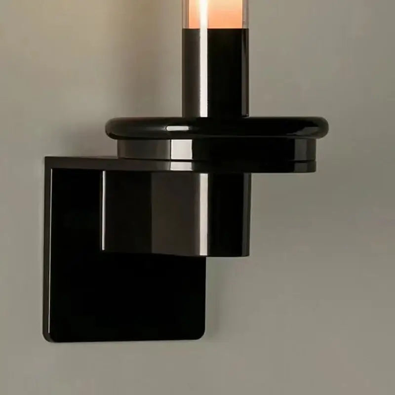 Modern black metal wall light with clear glass shade for bedroom
