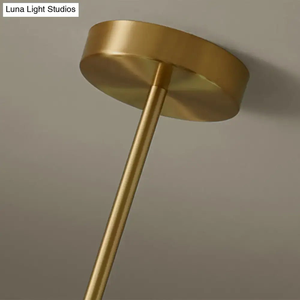 Modern brass 5-light pendant light with spherical glass shade dining room