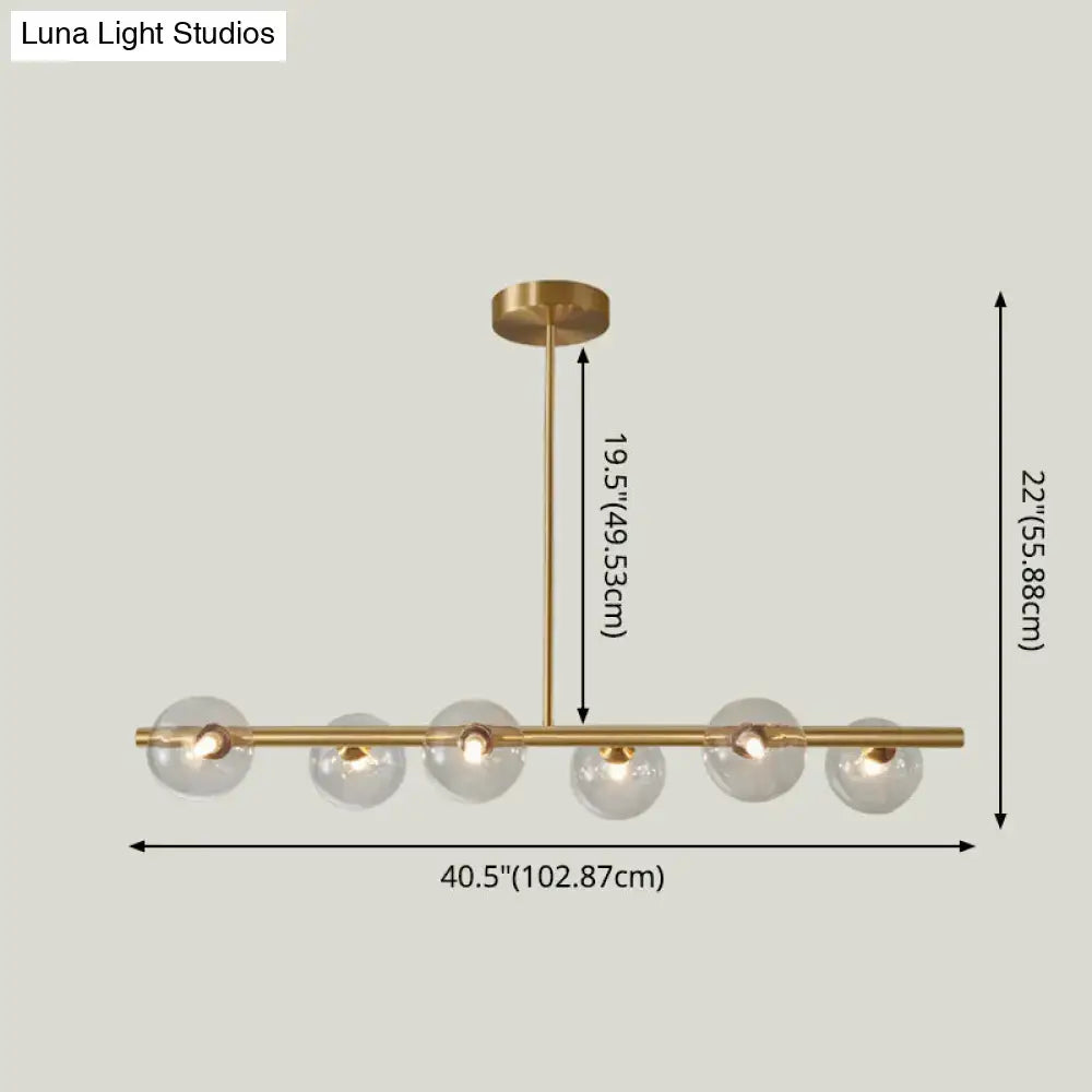 Modern brass 5-light pendant light with spherical glass shade dining room