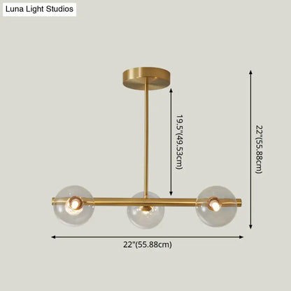 Modern brass 5-light pendant light with spherical glass shade dining room