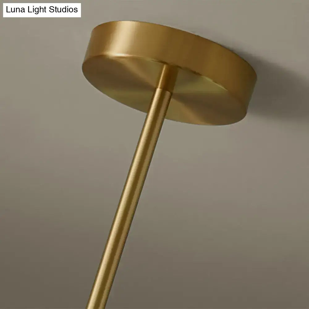 Modern brass 5-light pendant light with spherical glass shade dining room