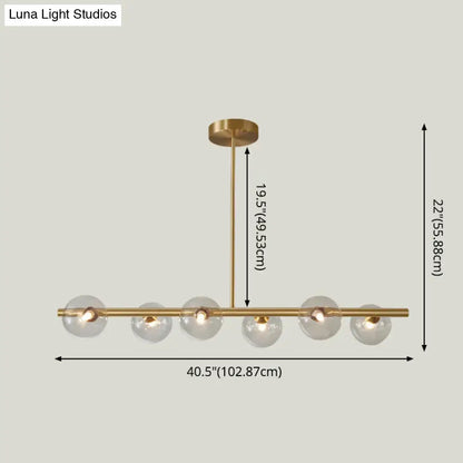 Modern brass 5-light pendant light with spherical glass shade dining room