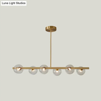 Modern brass 5-light pendant light with spherical glass shade dining room