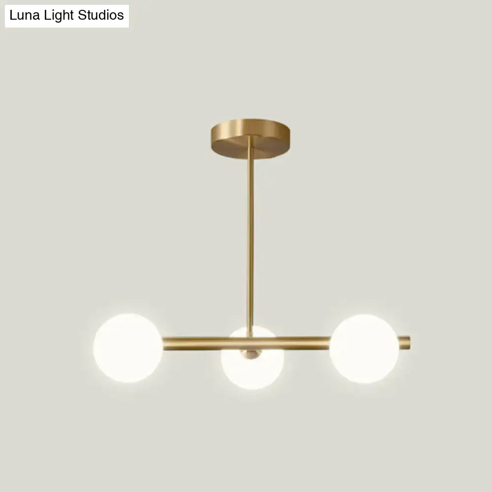 Modern brass 5-light pendant light with spherical glass shade dining room