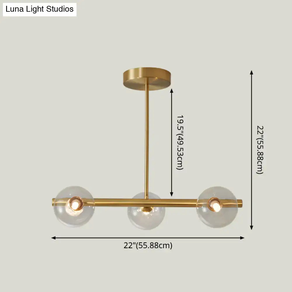 Modern brass 5-light pendant light with spherical glass shade dining room