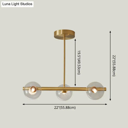 Modern brass 5-light pendant light with spherical glass shade dining room
