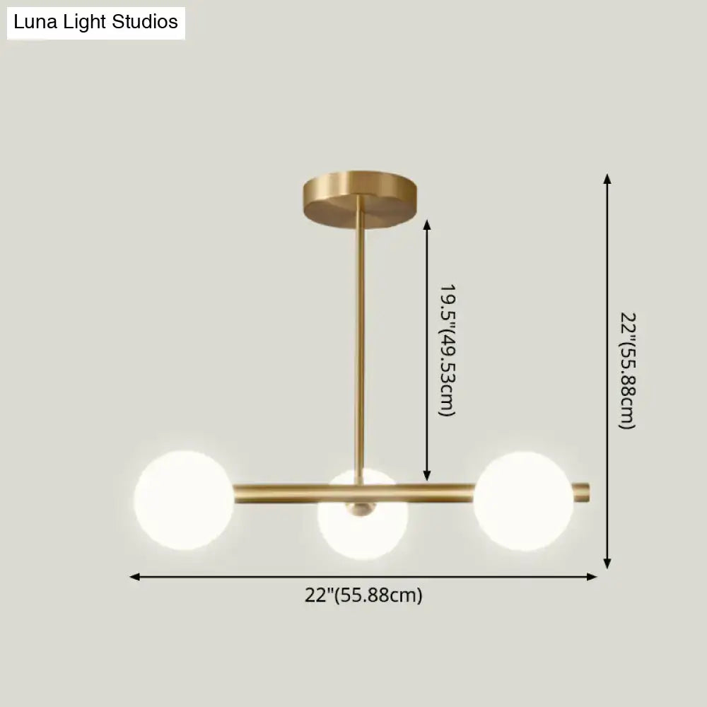 Modern brass 5-light pendant light with spherical glass shade dining room