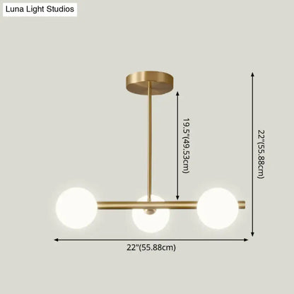 Modern brass 5-light pendant light with spherical glass shade dining room
