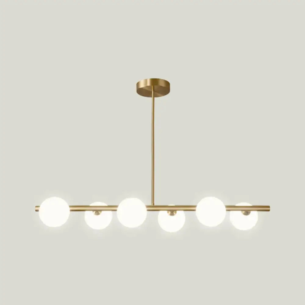 Modern brass 5-light pendant light with spherical glass shade dining room