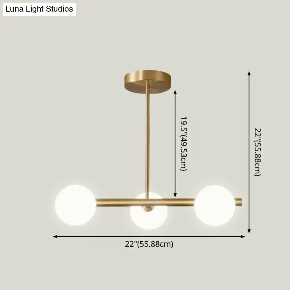 Modern brass 5-light pendant light with spherical glass shade dining room