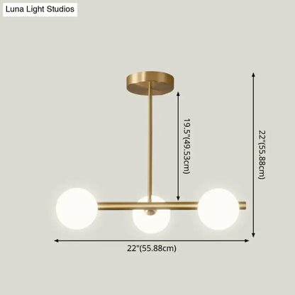 Modern brass 5-light pendant light with spherical glass shade dining room
