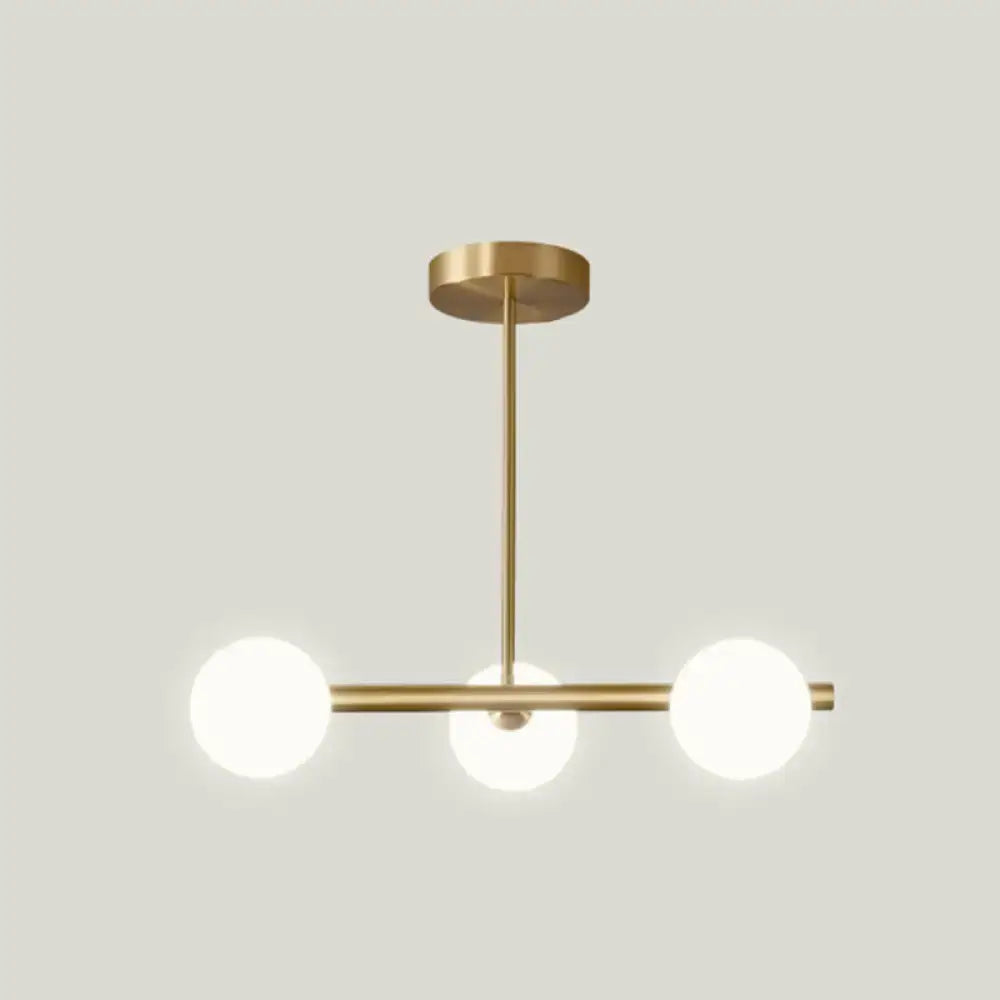 Modern brass 5-light pendant light with spherical glass shade dining room